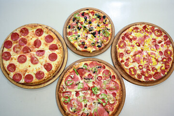 Traditional Turkish cuisine. Pizza, pita, pidesi, sucuk, hummus, kebab. Many dishes on the table. Serving dishes in restaurant. Margherita,  mix, formaggi, veggie karisik pizza. Top view, flat lay