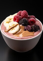 A bowl of fruit with a banana and raspberries