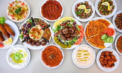 Delicious meat kebab with fresh vegetable salad served with variety of Turkish dishes and appetizers. Top view of assorted Turkish food and meze, tasty and healthy Mediterranean cuisine.