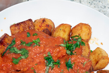 Close up of Porato Tapas Roasted Tomato auce Bravas