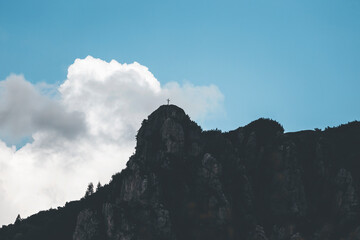 clouds over the mountain top with a cross