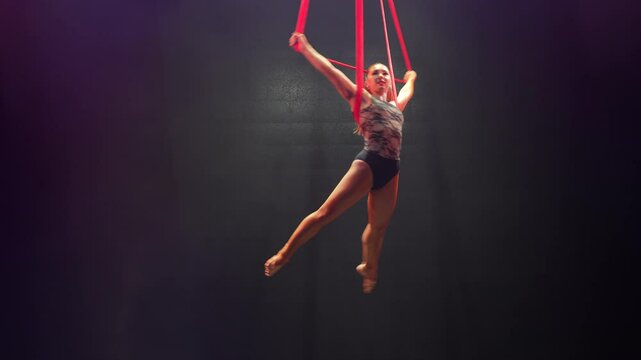 circus artist is doing a trick. aerial gymnastics.