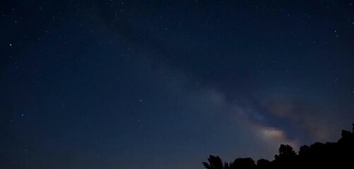 The night sky has shooting a star and the Milky Way in the background.
