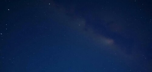 Fototapeta premium The night sky has shooting a star and the Milky Way in the background.