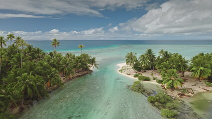 Turquoise water lagoon and two small palm tree covered islands on Tikehau atoll, part of French Polynesia Tuamotu archipelago. Remote wild nature paradise, exotic summer travel. Aerial drone flight