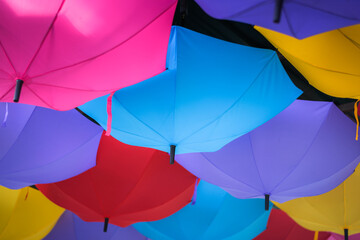 colorful umbrellas suspended upside down from ceiling