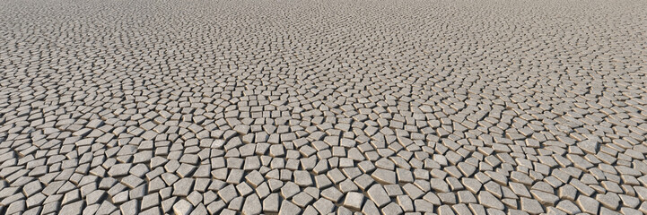 Irregular stone tiles forming geometric ground pattern
