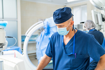 Surgeon readying for surgery. A healthcare professional in scrubs focuses intently before a surgical operation in a modern operating room.