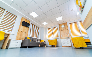 Cozy waiting area with modern decor. A bright waiting area features yellow chairs, a sofa, and...