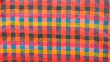 A colorful checkered fabric with a red and yellow square
