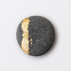 Decorative gray stone with a striking gold accent showcasing artistic transformation and natural beauty