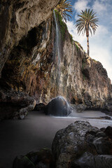 Waterfall at black sand beach Playa del Castro, Tenerife © viktoriya89