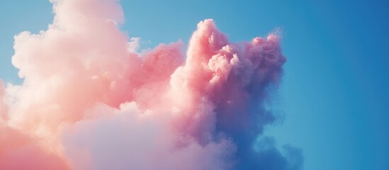 Colorful powder explosion amidst soft clouds against a bright sky backdrop with space for customizable text and creative designs