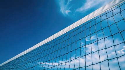 Volleyball Net Stretching Across a Clear Blue Sky with Wispy Clouds in a Bright Sunny Day Environment