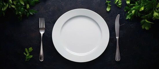 Elegant dinner table setting with empty white plate and cutlery on dark background perfect for gourmet dining presentations