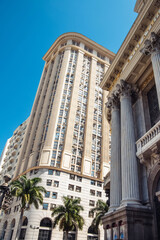 In Rio, historic buildings and modern skyscrapers coexist under a clear blue sky, showcasing urban evolution.