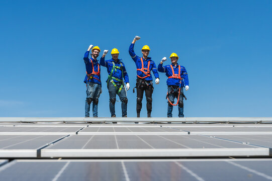 Group of solar technician teammates working together on solar roof installation
