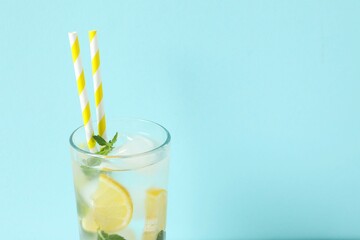 Summer refreshing lemonade drink or alcoholic cocktail with ice, mint and lemon slices on the...