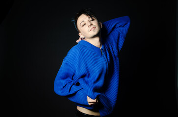 Young attractive man posing in blue sweater