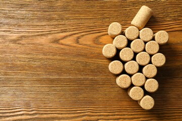 Wine corks in the shape of grapes  on a wooden background. Top view with copy space for text