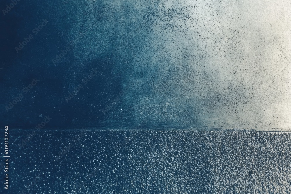 Poster a textured surface with a gradient of deep blue and gray tones, creating an abstract backdrop.