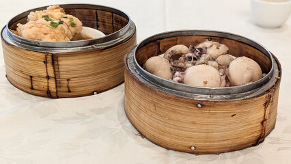 Photo of Steamed delicacies served in bamboo baskets, showcasing traditional Chinese dim sum...