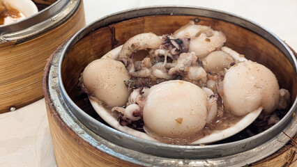 Photo of Steamed delicacies served in bamboo baskets, showcasing traditional Chinese dim sum...