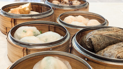 Photo of Steamed delicacies served in bamboo baskets, showcasing traditional Chinese dim sum cuisine. Concept of Chinese new year, lunar year, dim sum, dumpling, authenticity, celebration