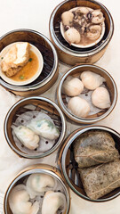 Photo of Steamed delicacies served in bamboo baskets, showcasing traditional Chinese dim sum cuisine. Concept of Chinese new year, lunar year, dim sum, dumpling, authenticity, celebration