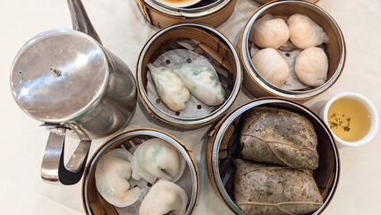 Photo of Steamed delicacies served in bamboo baskets, showcasing traditional Chinese dim sum cuisine. Concept of Chinese new year, lunar year, dim sum, dumpling, authenticity, celebration
