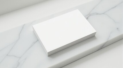 Elegant white business card on a marble slab with green leaves, showcasing minimalistic design and sophistication