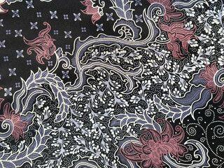 Close up of traditional ethnic random floral and ornamental pattern in black, grey, and pink color....