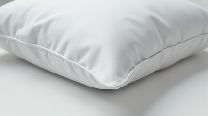 A close-up image of a crisp white pillow corner showcases smooth, soft fabric texture on a light background, highlighting minimalistic bedding design