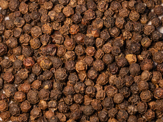 Black peppercorns. Spice close-up. The selected sharpness. round black pepper background