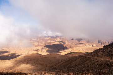 A cloudy sky with a mountain range in the background