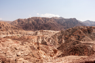 A desert landscape with mountains in the background