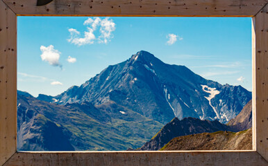 Alpine summer view with a wooden foto frame at Mount Flimjoch, Ischgl, Paznaun, Silvretta, Landeck, Tyrol, Austria