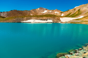 Obraz premium Alpine summer view with reflections in a lake at Mount Flimjoch, Ischgl, Paznaun, Silvretta, Landeck, Tyrol, Austria