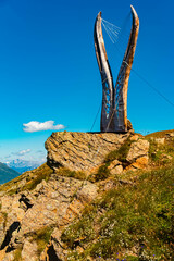 Alpine summer view with a chamois horns sculpture at Mount Schoenjoch, Fiss, Inntal valley, Samnaun, Landeck, Tyrol, Austria