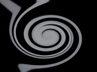 黒背景に白の渦巻のイメージ画像。イラスト風の写真。