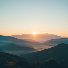 Fototapeta premium Serene sunrise over misty mountain range.