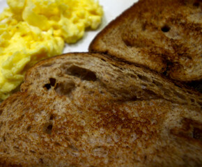 meal details. toasted bread with scrambled egg. slices of bread with egg.