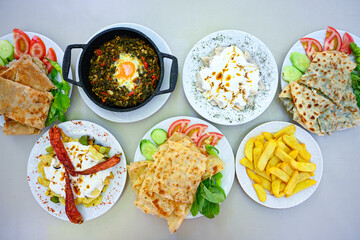 Delicious meat kebab with fresh vegetable salad served with variety of Turkish dishes and appetizers. Top view of assorted Turkish food and meze, tasty and healthy Mediterranean cuisine.