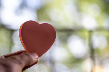 Man holding a 3d heart shape with casual background