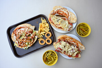 Delicious meat kebab with fresh vegetable salad served with variety of Turkish dishes and appetizers. Top view of assorted Turkish food and meze, tasty and healthy Mediterranean cuisine.