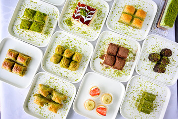 Turkish Dessert Sobiyet, havuc dilimi, midye baklava, mussels baklava and classic baklava with Pistachio . Cikolatali cevizli, fistikli soguk Baklava, top view.