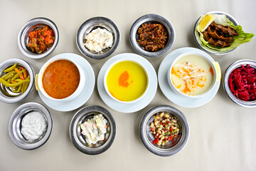 Delicious meat kebab with fresh vegetable salad served with variety of Turkish dishes and appetizers. Top view of assorted Turkish food and meze, tasty and healthy Mediterranean cuisine.