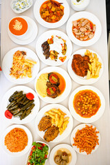 Delicious meat kebab with fresh vegetable salad served with variety of Turkish dishes and appetizers. Top view of assorted Turkish food and meze, tasty and healthy Mediterranean cuisine.