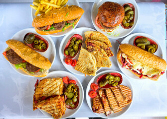 Delicious meat kebab with fresh vegetable salad served with variety of Turkish dishes and appetizers. Top view of assorted Turkish food and meze, tasty and healthy Mediterranean cuisine.