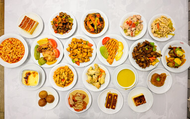 Delicious meat kebab with fresh vegetable salad served with variety of Turkish dishes and appetizers. Top view of assorted Turkish food and meze, tasty and healthy Mediterranean cuisine.
